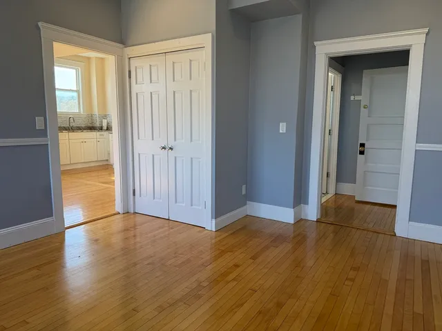a view of wooden floor and windows in a room