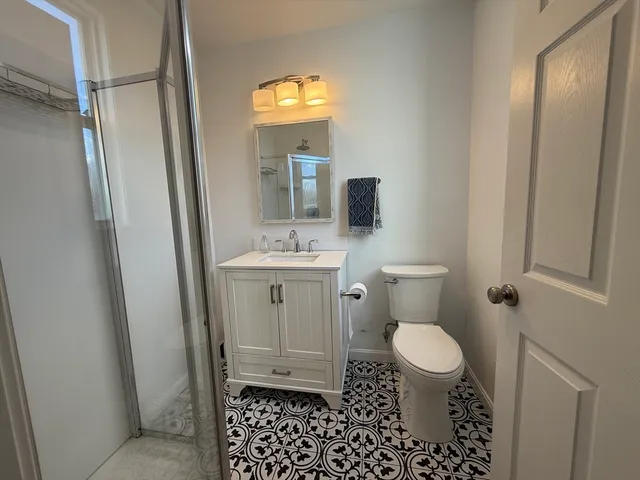 a bathroom with a sink toilet and shower
