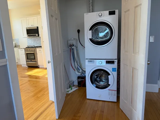 a utility room with sink dryer and washer