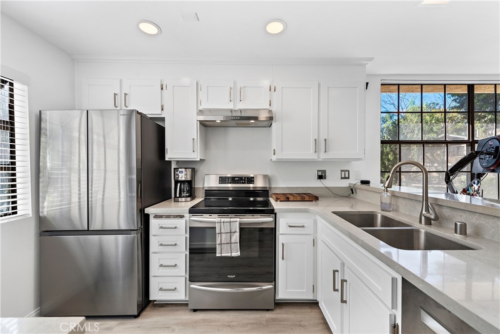 165 Pineview Irvine, CA 92620 - Photo 4 of 23 a kitchen with a refrigerator sink and cabinets