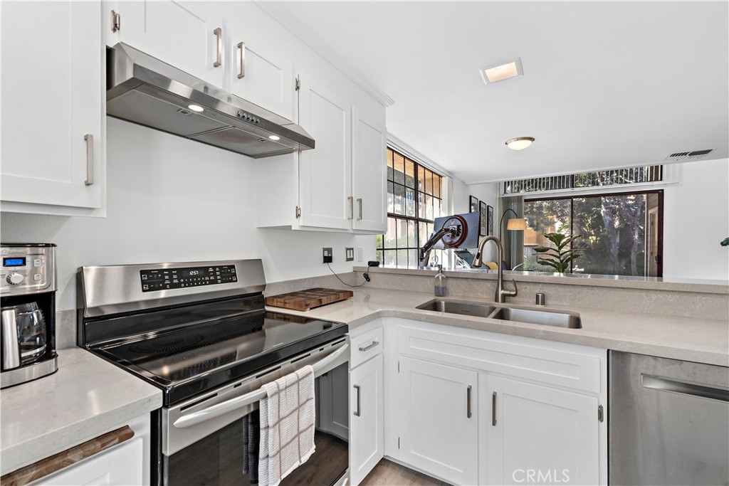 165 Pineview Irvine, CA 92620 - Photo 5 of 23 a kitchen with stainless steel appliances a sink a stove and cabinets
