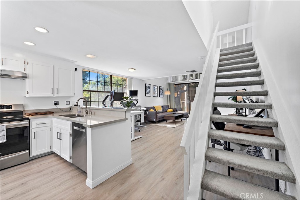 165 Pineview Irvine, CA 92620 - Photo 7 of 23 a kitchen with stainless steel appliances and white cabinets
