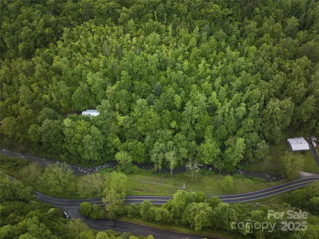 an aerial view of a houses with yard