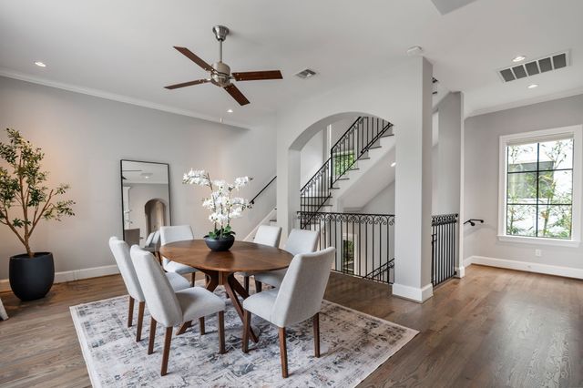 a dining room with furniture window and wooden floor