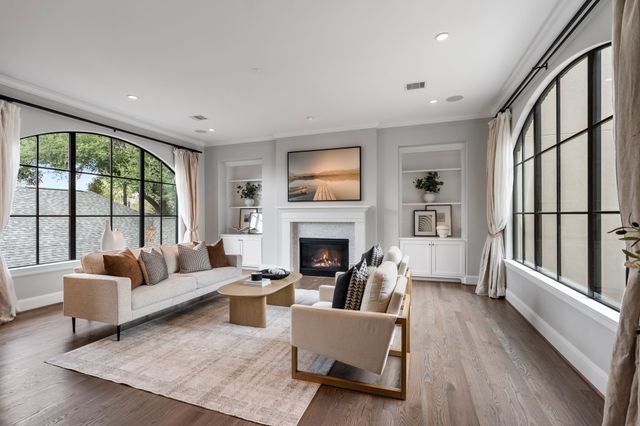 a living room with furniture large window and a fireplace