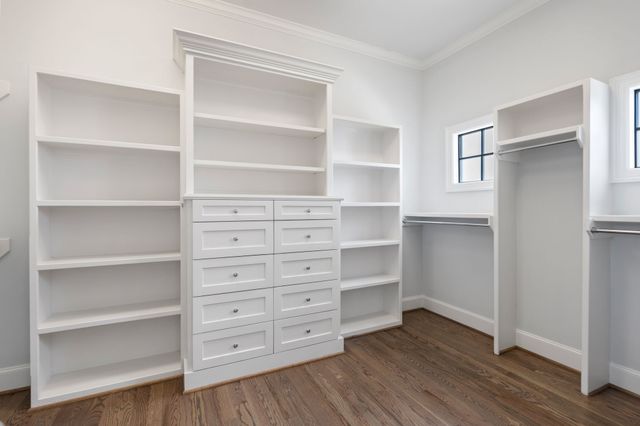 a view of walk in closet with empty racks