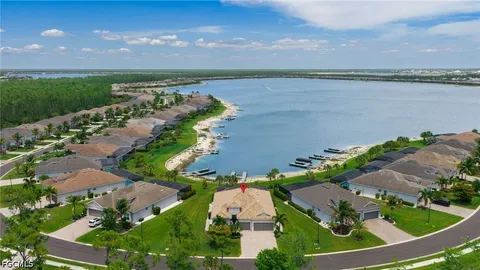 an aerial view of a house with a yard and lake view