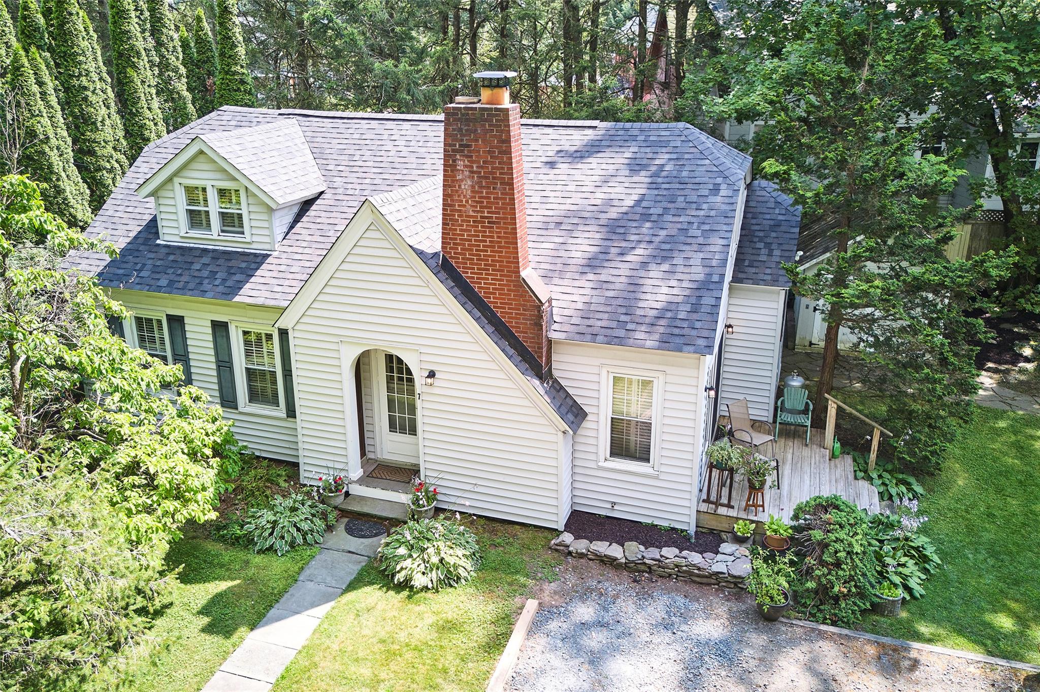a front view of a house with a garden