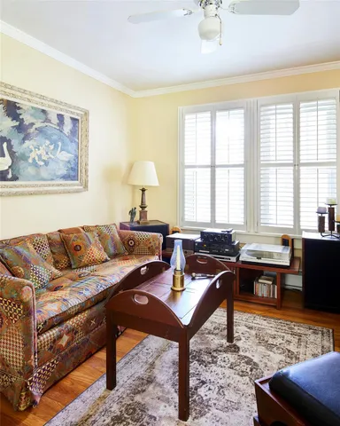 a living room with a bed and a book shelf