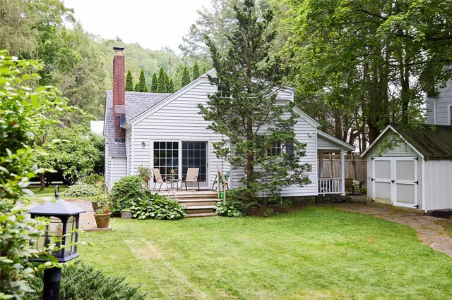 a front view of a house with a garden