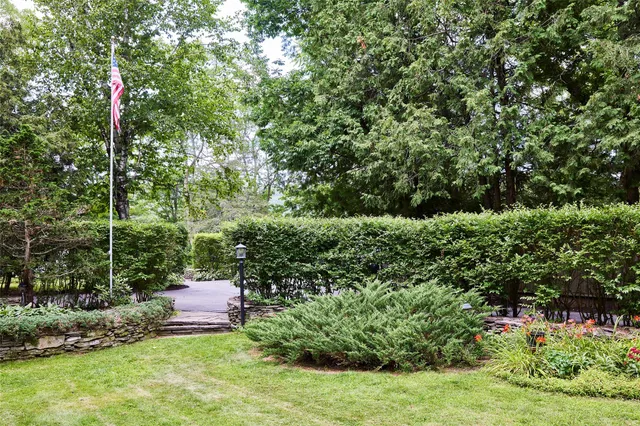 a view of a chair and table in the garden