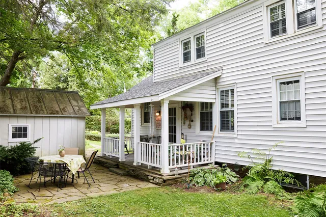 a view of a house with backyard and sitting area