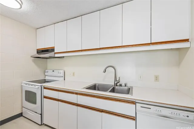 a kitchen with stainless steel appliances granite countertop a sink a stove and cabinets