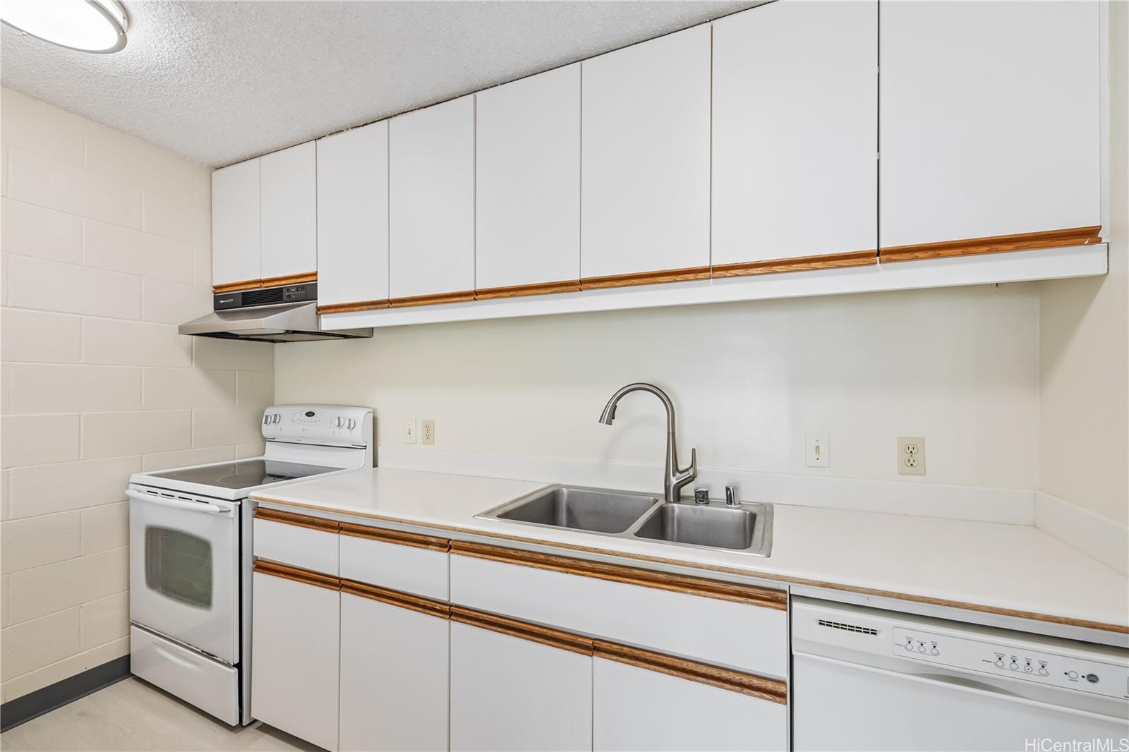 1687 Pensacola Street, Unit 804 Honolulu, HI 96822 - Photo 6 of 22 a kitchen with stainless steel appliances granite countertop a sink a stove and cabinets