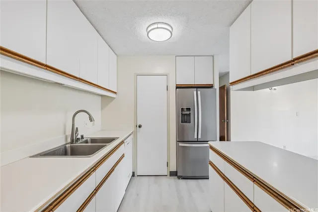 a kitchen with stainless steel appliances a refrigerator and a sink