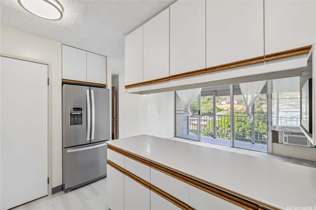 a kitchen with windows and refrigerator
