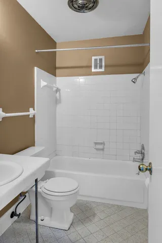 a bathroom with a toilet and a bath tub