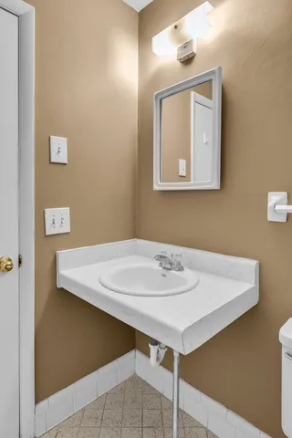 a bathroom with a sink vanity and a mirror