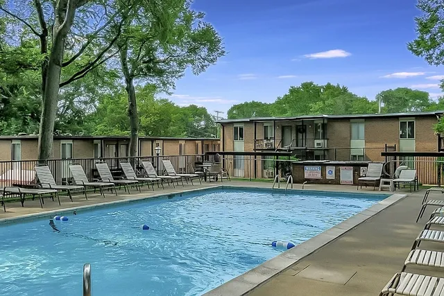 a view of a deck with chairs next to a yard