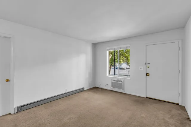 a view of an empty room with a window