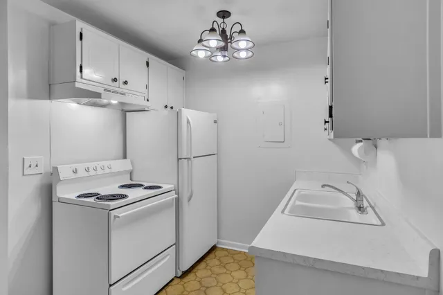 a view of kitchen with refrigerator stove and microwave
