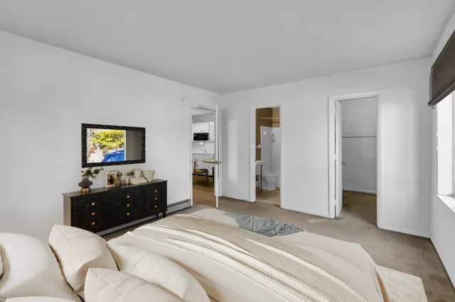 a bedroom with a bed and a dresser