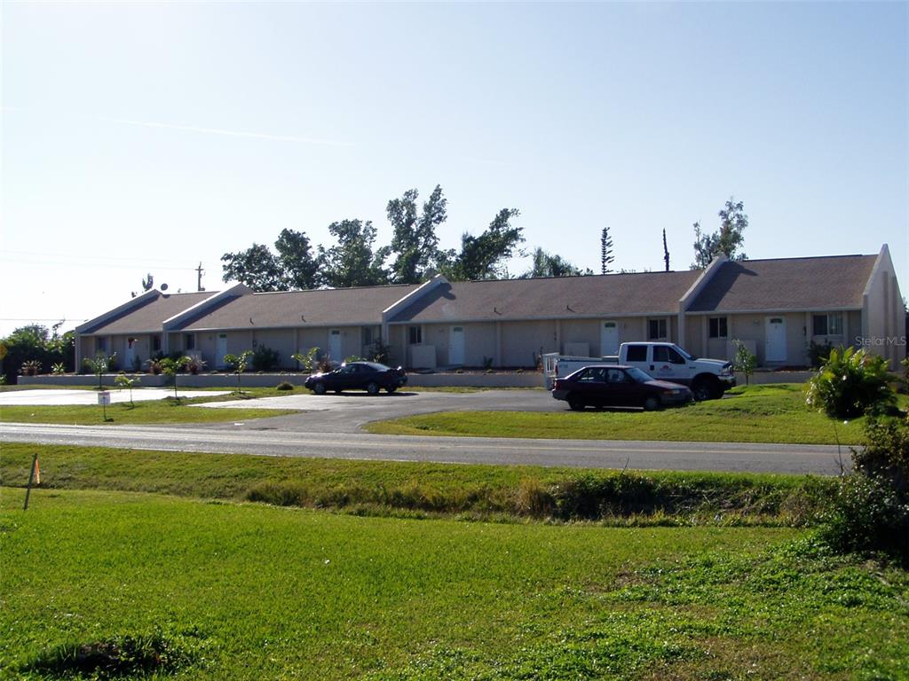 3121 Vasco Street, Unit 1 Punta Gorda, FL 33950 - Photo 1 of 5 a aerial view of a house with swimming pool and a yard