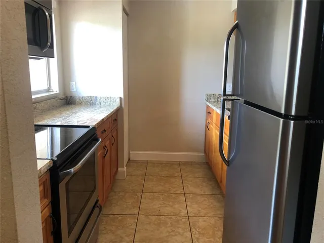 a kitchen with a refrigerator and window