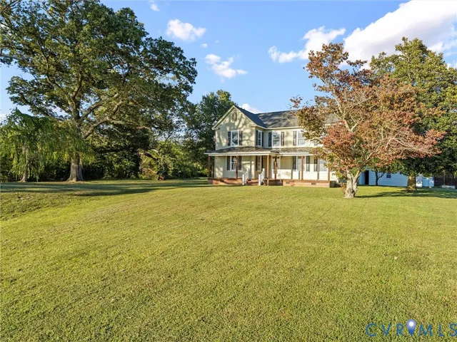 a front view of a house with a big yard