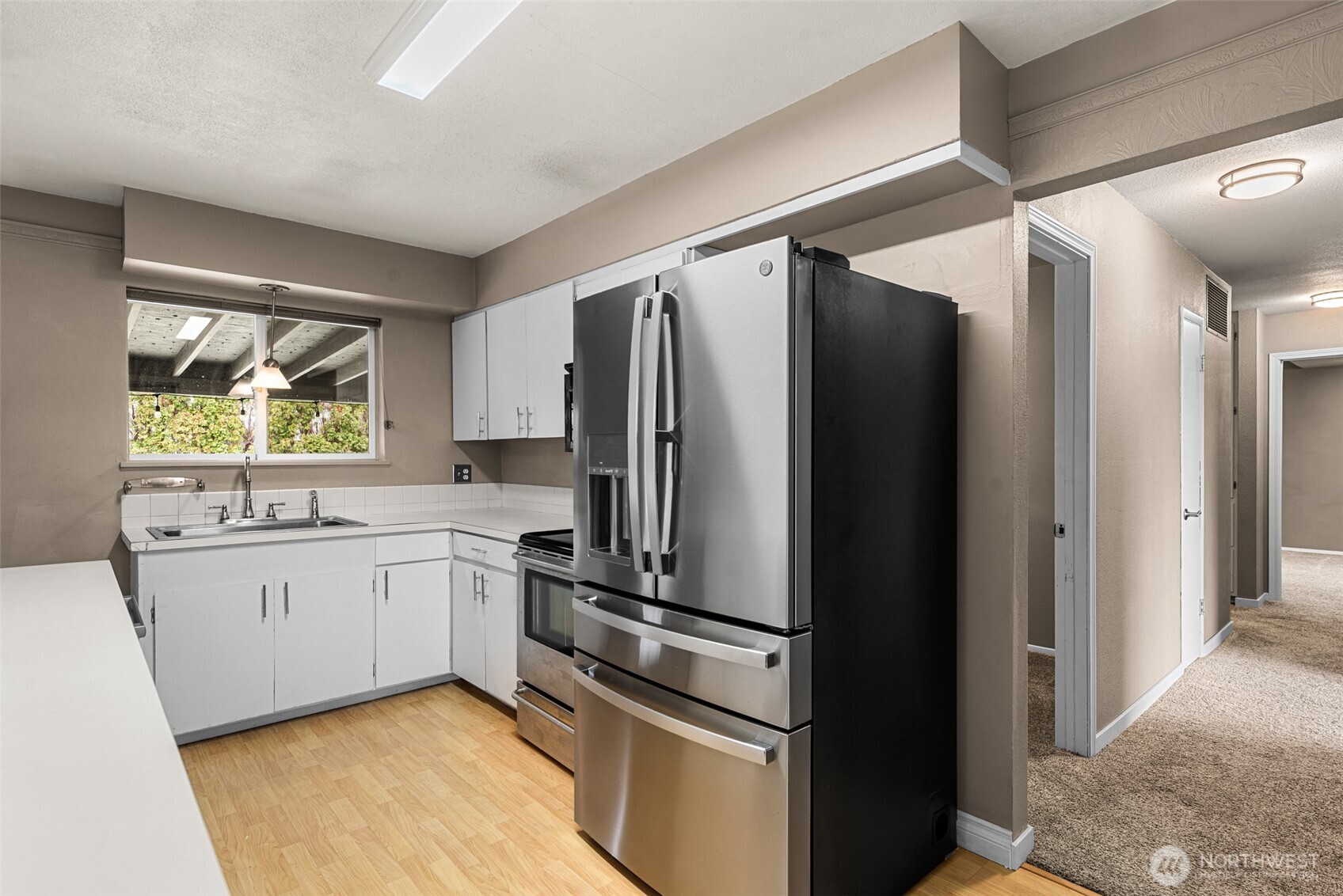 709 Schons Place Wenatchee, WA 98801 - Photo 11 of 28 a kitchen with stainless steel appliances a refrigerator sink and stove