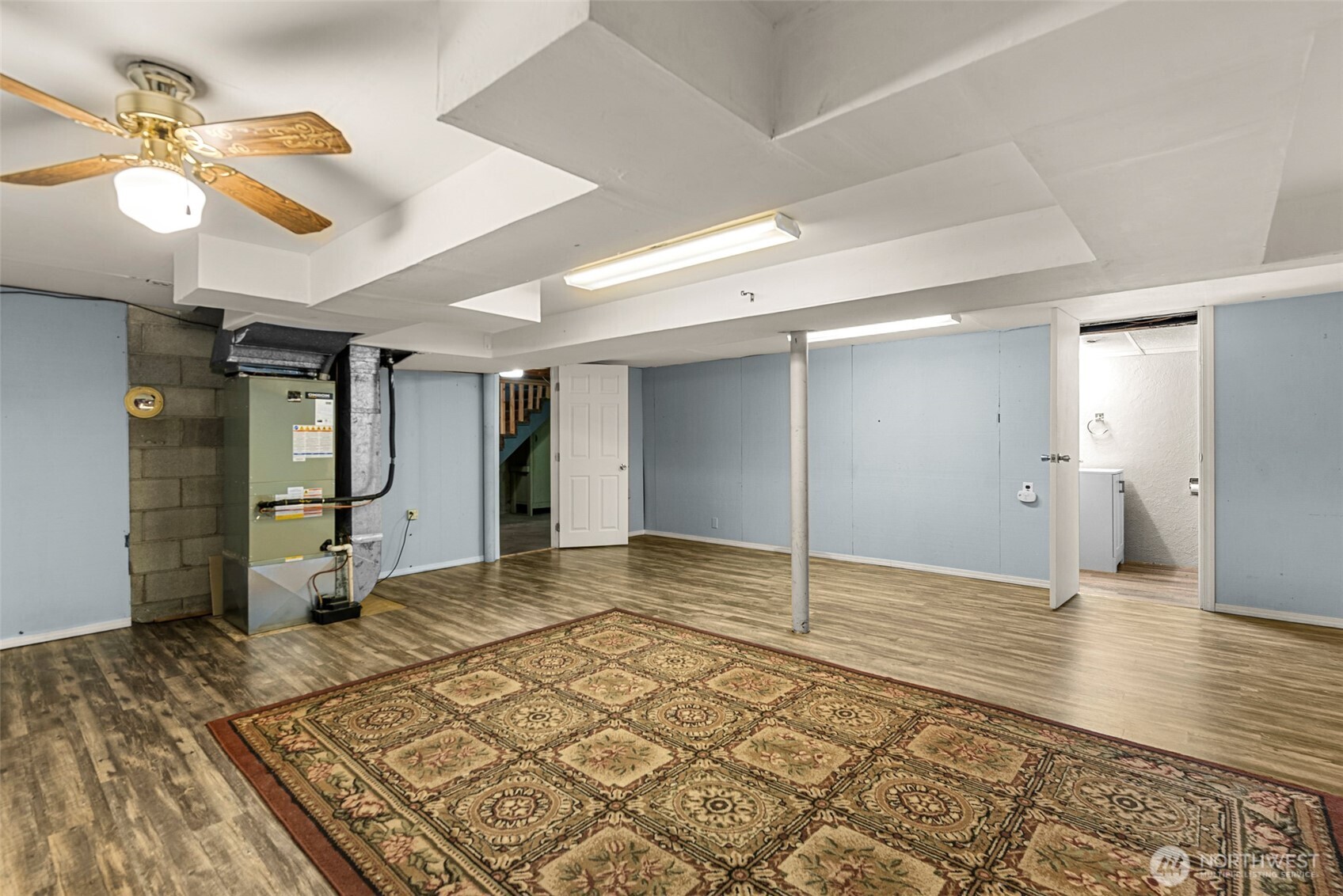 709 Schons Place Wenatchee, WA 98801 - Photo 23 of 28 a view of a livingroom with wooden floor and a ceiling fan