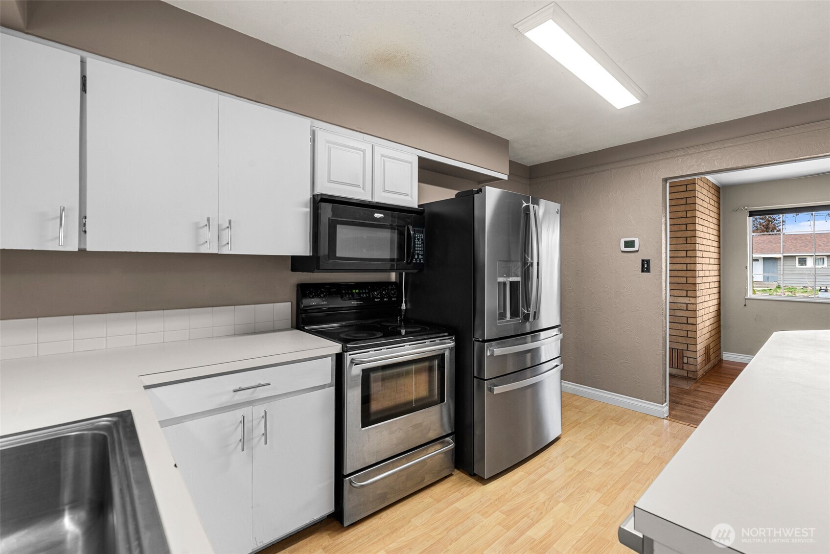 709 Schons Place Wenatchee, WA 98801 - Photo 9 of 28 a kitchen with stainless steel appliances white cabinets and a refrigerator