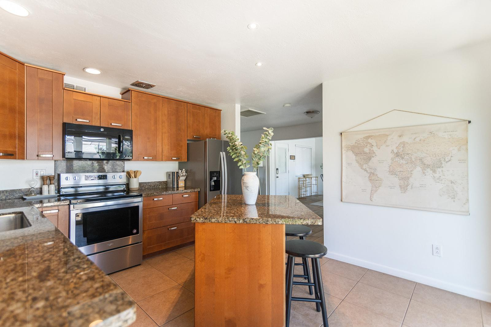 7435 East Granada Road Scottsdale, AZ 85257 - Photo 12 of 28 a kitchen with stainless steel appliances granite countertop a refrigerator a stove top oven a sink and dishwasher
