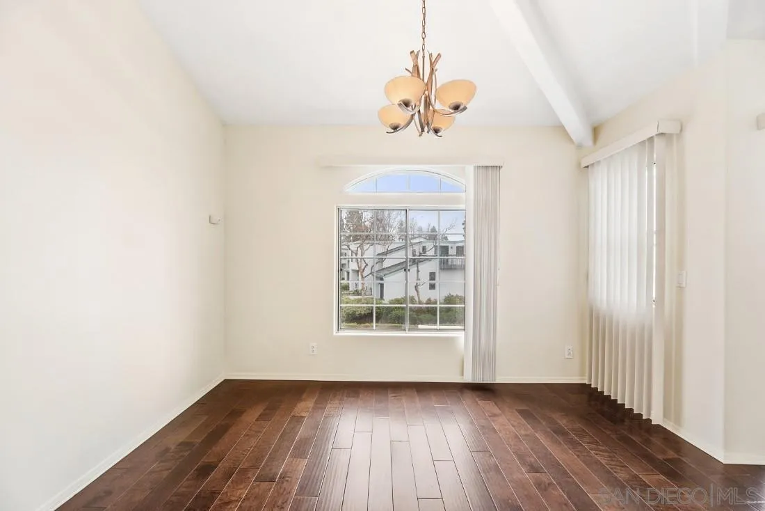 8637 Via Mallorca, Unit E La Jolla, CA 92037 - Photo 13 of 34 a view of an empty room with wooden floor and a window