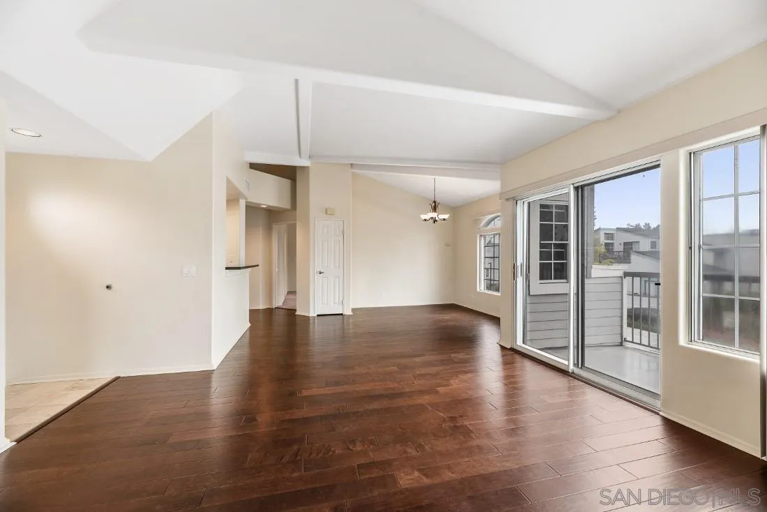 8637 Via Mallorca, Unit E La Jolla, CA 92037 - Photo 15 of 34 an empty room with wooden floor and windows