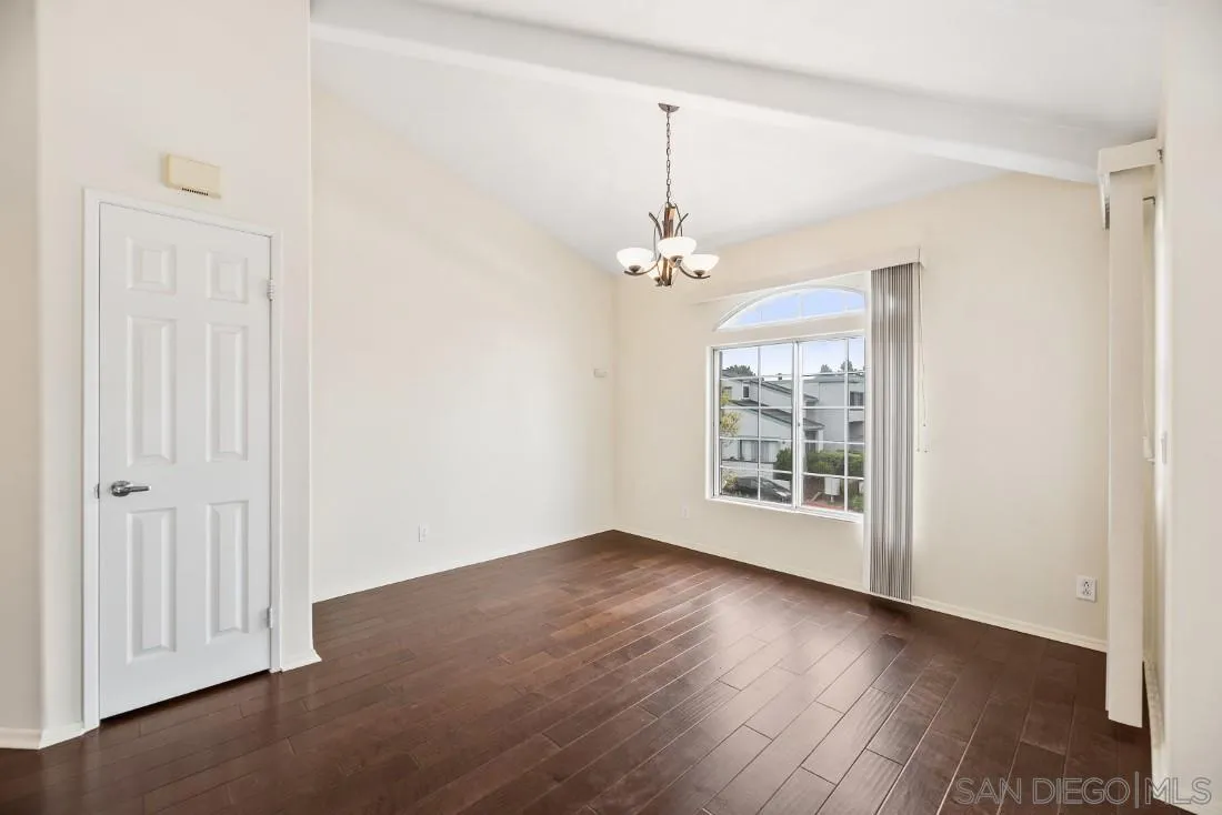 8637 Via Mallorca, Unit E La Jolla, CA 92037 - Photo 17 of 34 a view of an empty room with wooden floor and a window