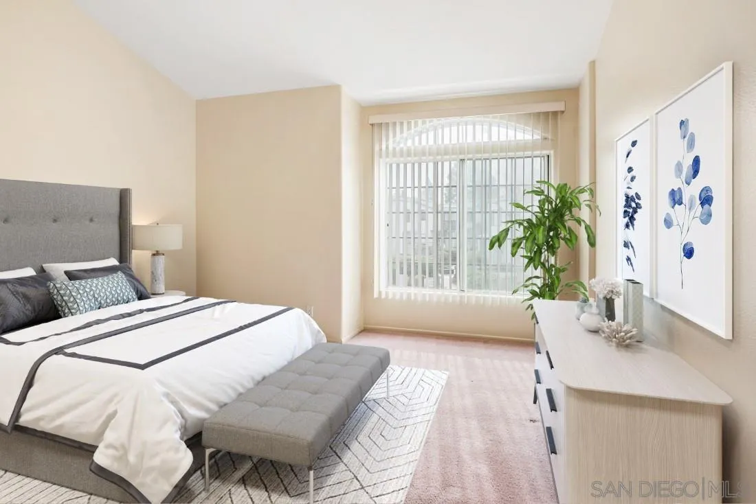8637 Via Mallorca, Unit E La Jolla, CA 92037 - Photo 18 of 34 a spacious bedroom with a bed and a window