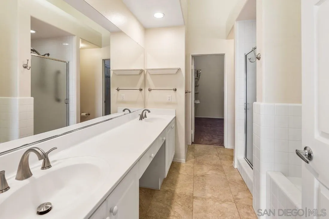 8637 Via Mallorca, Unit E La Jolla, CA 92037 - Photo 21 of 34 a spacious bathroom with a tub sink and mirror