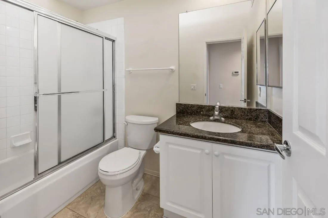 8637 Via Mallorca, Unit E La Jolla, CA 92037 - Photo 25 of 34 a bathroom with a granite countertop sink toilet and shower