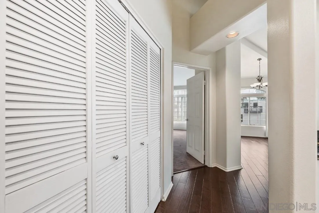 8637 Via Mallorca, Unit E La Jolla, CA 92037 - Photo 26 of 34 a view of a hallway with wooden floor