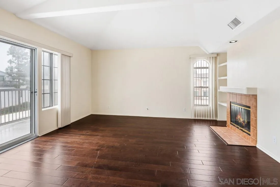 8637 Via Mallorca, Unit E La Jolla, CA 92037 - Photo 3 of 34 a view of an empty room with wooden floor and a window