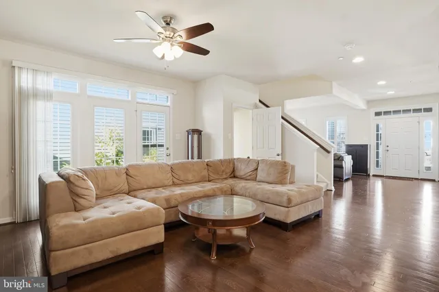 a living room with furniture and a large window with rug floor