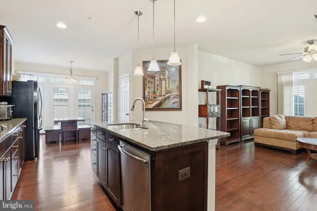 a open kitchen with stainless steel appliances granite countertop a stove and a refrigerator