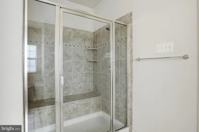 a bathroom with a glass shower door