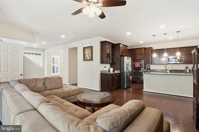 a living room with furniture and kitchen view