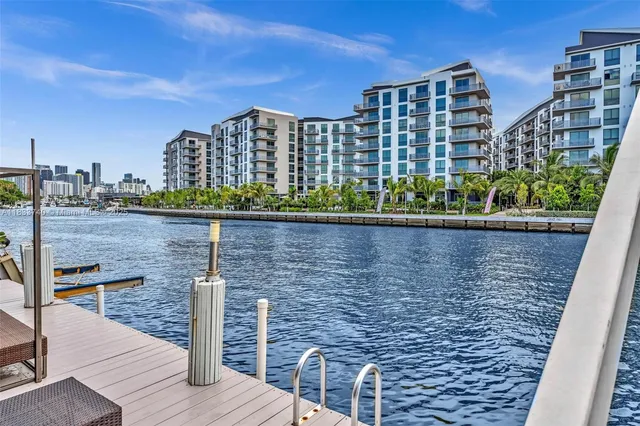 a kitchen with stainless steel appliances lots of white furniture stove and sink