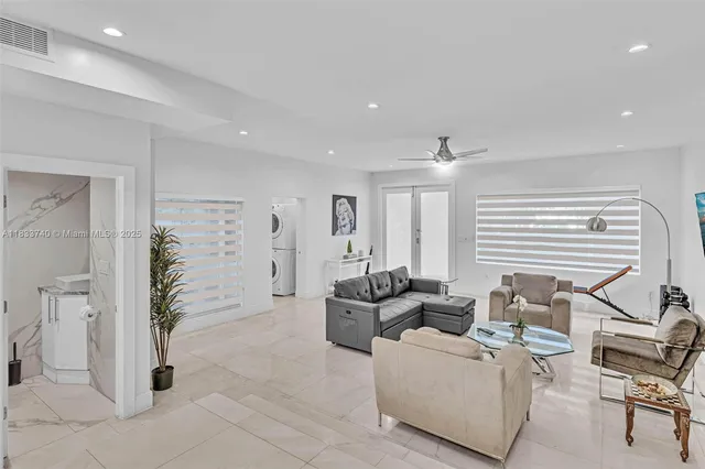 a kitchen with stainless steel appliances kitchen island a stove a refrigerator a dining table and chairs