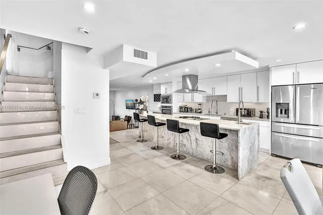 a bedroom with a bed a flat screen tv and a large window