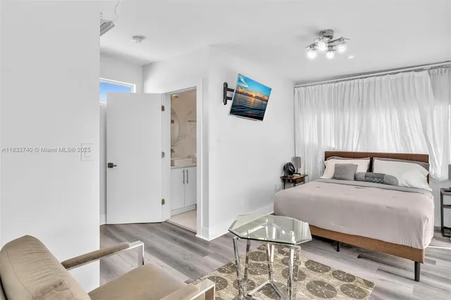 a room with a large window and furniture