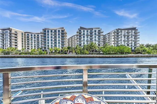 a view of a rooftop deck with couch and chairs
